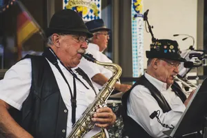 Elderly musicians perform with saxophone and trumpet at an Oktoberfest festival outdoors. jigsaw puzzle