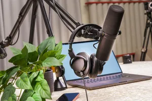A modern podcast studio setup with a microphone, headphones, and laptop, ideal for media production and online broadcasting. jigsaw puzzle