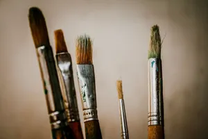 A detailed view of various paintbrushes used for artistic projects in a studio setting. jigsaw puzzle