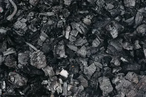 Top view black and white of textured background representing charcoal with rough surface and dense structure jigsaw puzzle