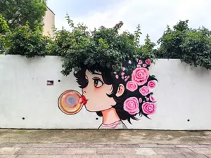 Colorful street art mural of a girl blowing a bubble, adorned with roses. jigsaw puzzle
