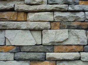 Close-up of a textured stone wall with a variety of natural colors. jigsaw puzzle