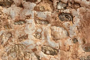 Close-up of a rustic stone wall with cracked, earthy textures, perfect for backgrounds. jigsaw puzzle