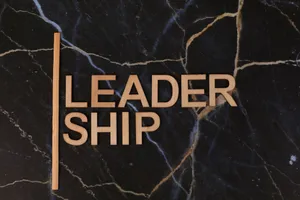 Wooden letters spelling 'Leadership' on a dark marble surface, symbolizing strength and elegance. jigsaw puzzle