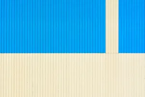 Vibrant blue and cream wall pattern with vertical lines for creative design uses. jigsaw puzzle