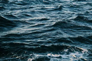 A breathtaking view of ocean waves in motion with deep blue tones. jigsaw puzzle